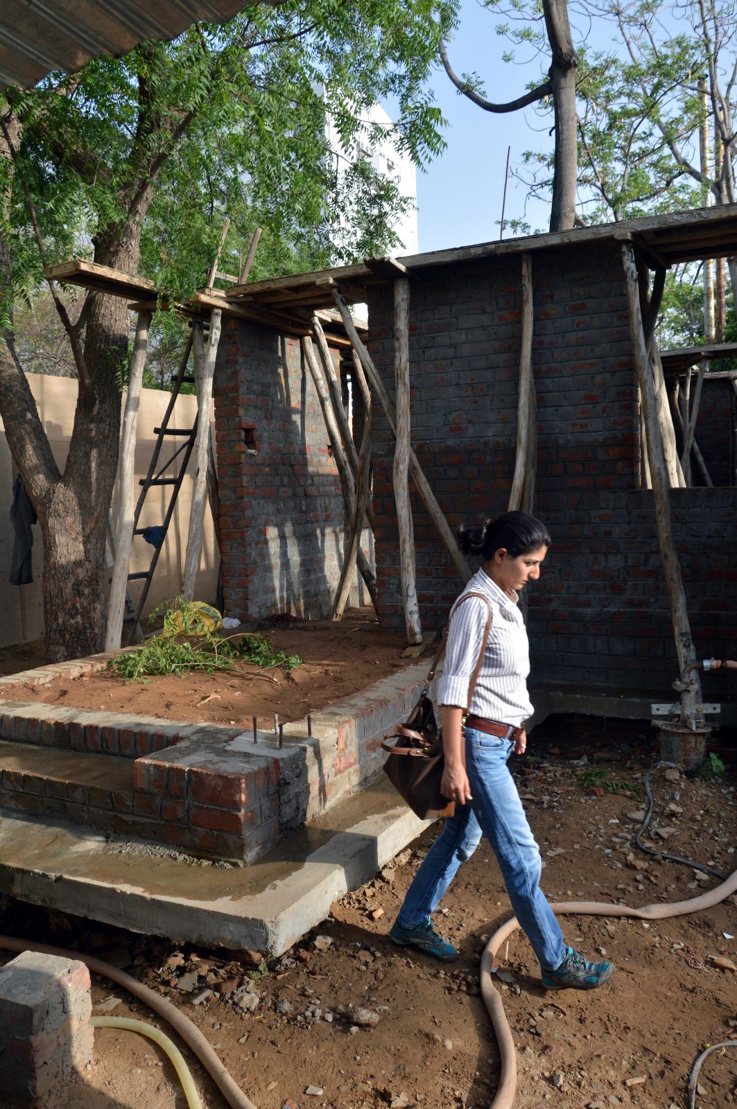Shreenu Mukherjee inspects a project construction site.
