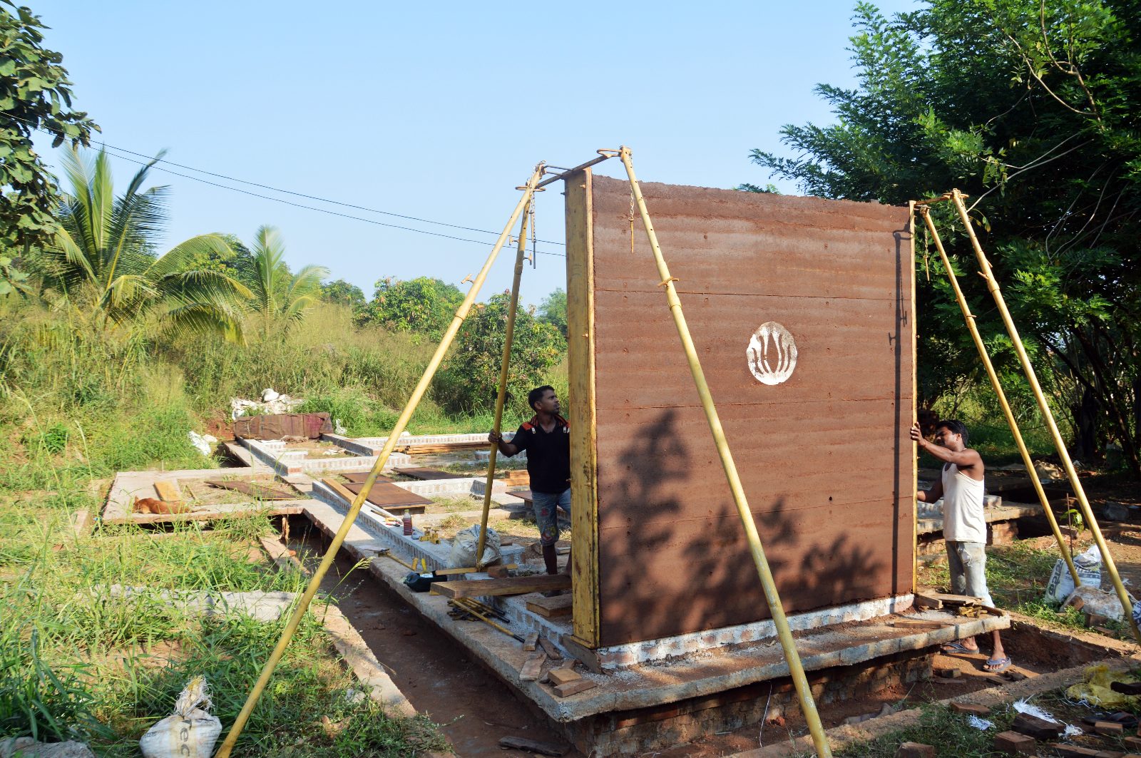 Rammed earth farm house, Thane, Mumbai: rammed-earth formwork workers, construction photograph.